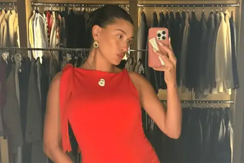 Hailey Bieber Slays Maternity Fashion in a Chic Red Minidress